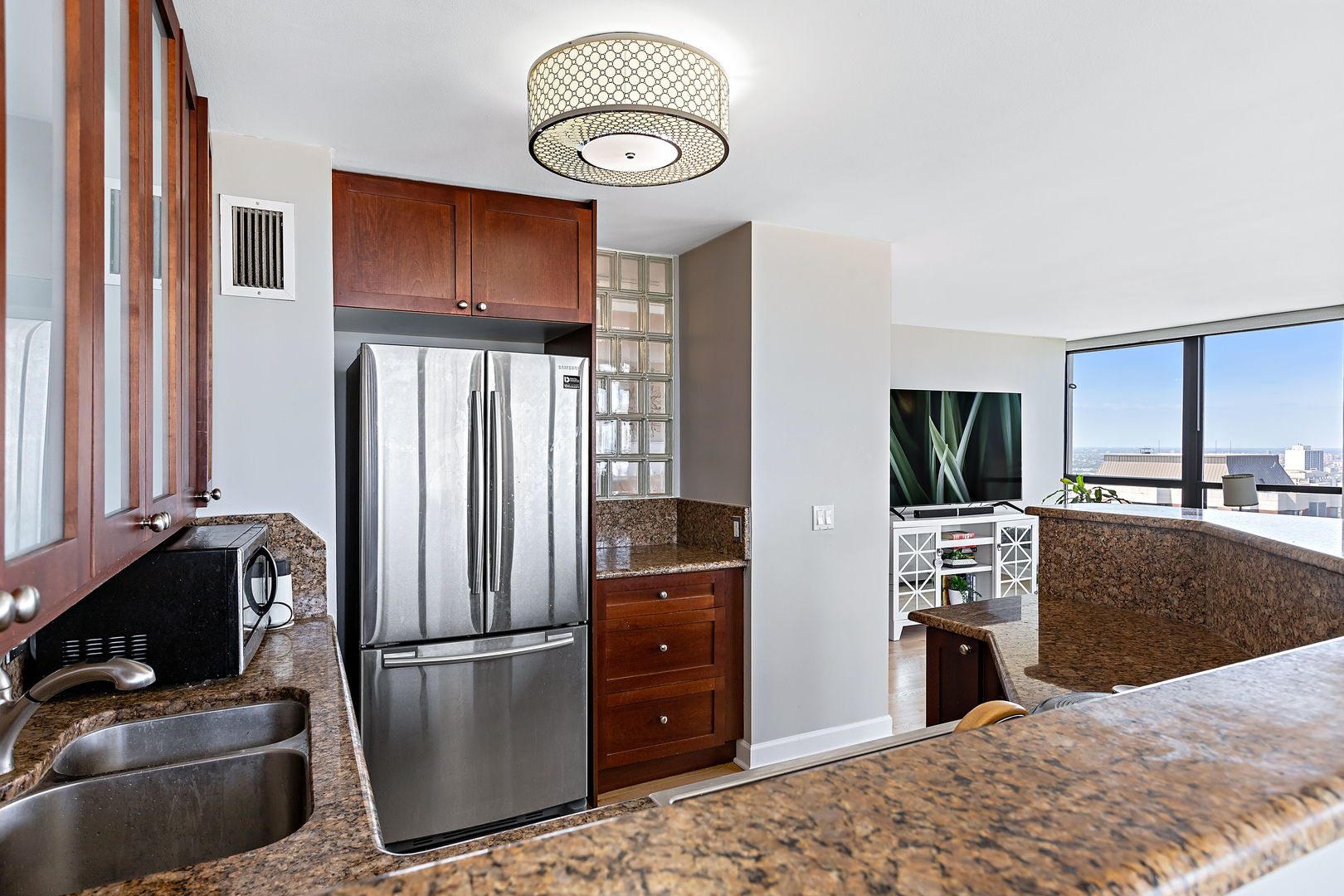 1030 North State Street, Unit 31E Chicago, IL 60610 - Photo 6 of 19 a kitchen with stainless steel appliances granite countertop a refrigerator stove and microwave