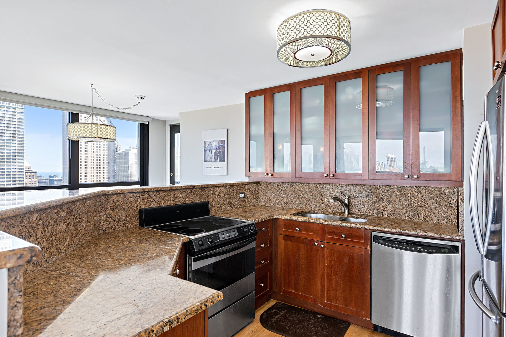 1030 North State Street, Unit 31E Chicago, IL 60610 - Photo 7 of 19 a kitchen with granite countertop a stove and a sink
