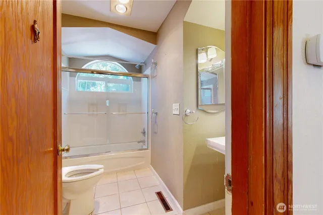 a bathroom with a glass shower door