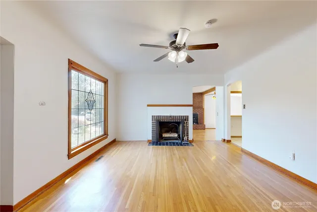 a view of main area fire place window and wooden floor