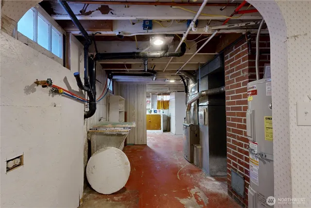 a view of an empty room with wooden floor and windows