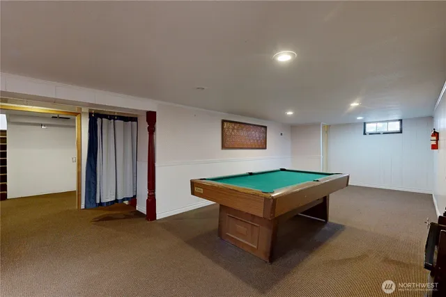 a room with pool table and a projector