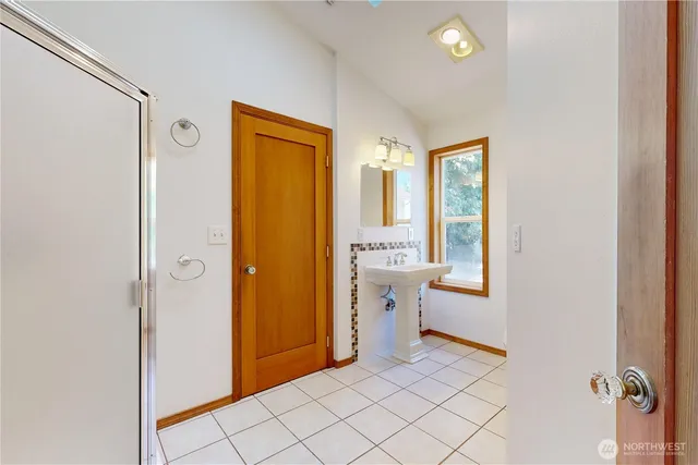a view of a hallway with bathroom and a bathroom