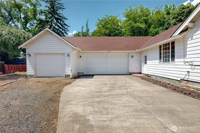 a view of a house with a yard and garage