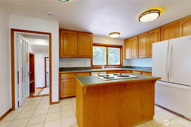 a kitchen with stainless steel appliances granite countertop a stove a refrigerator and a refrigerator