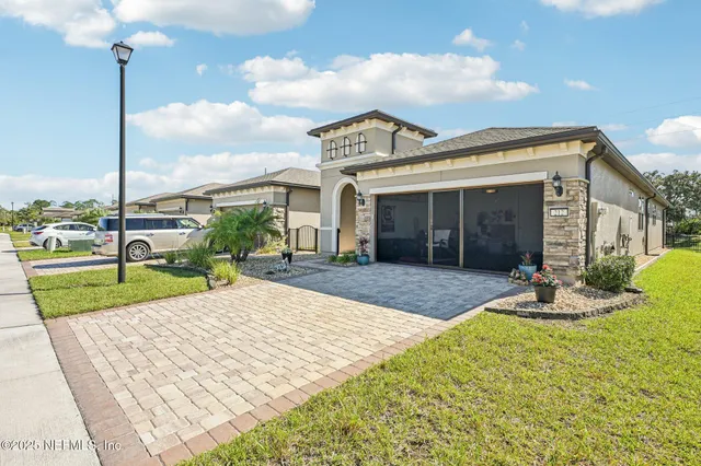 a front view of a house with a garden and yard
