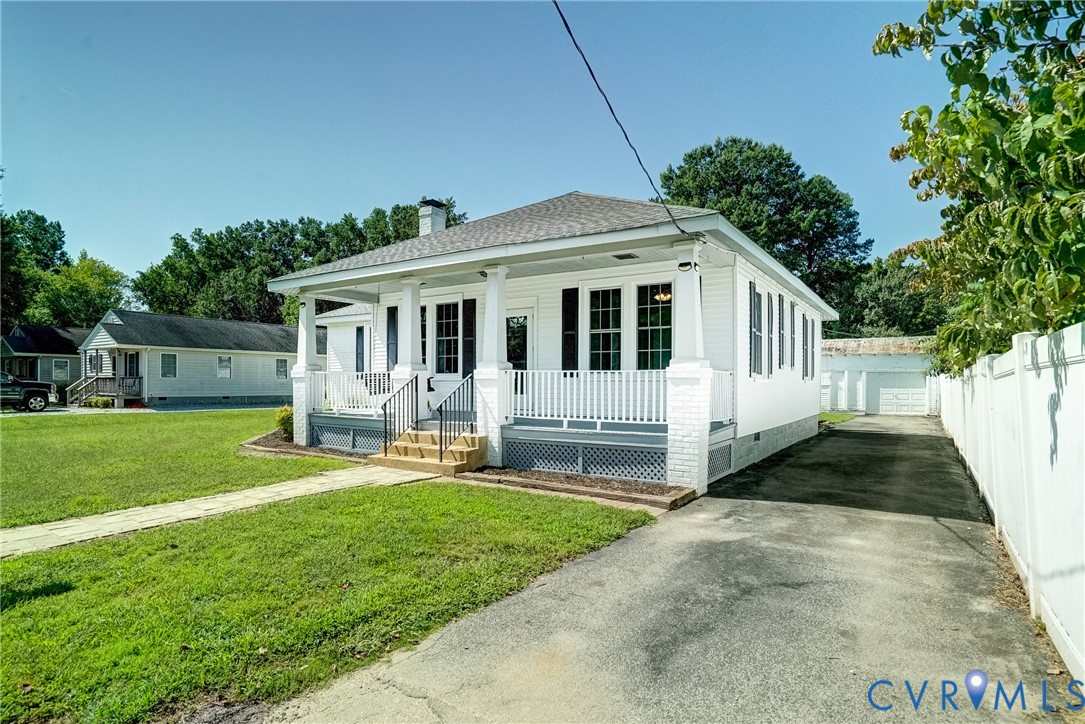 10024 Washington Road Glen Allen, VA 23060 - Photo 3 of 47 White siding exterior with a covered porch and rai