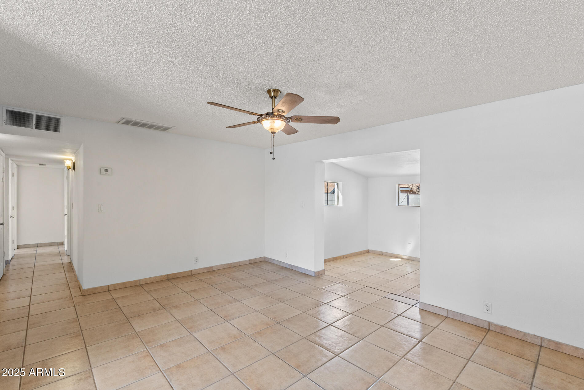 2230 East Chipman Road Phoenix, AZ 85040 - Photo 12 of 26 a view of a livingroom with a ceiling fan and window