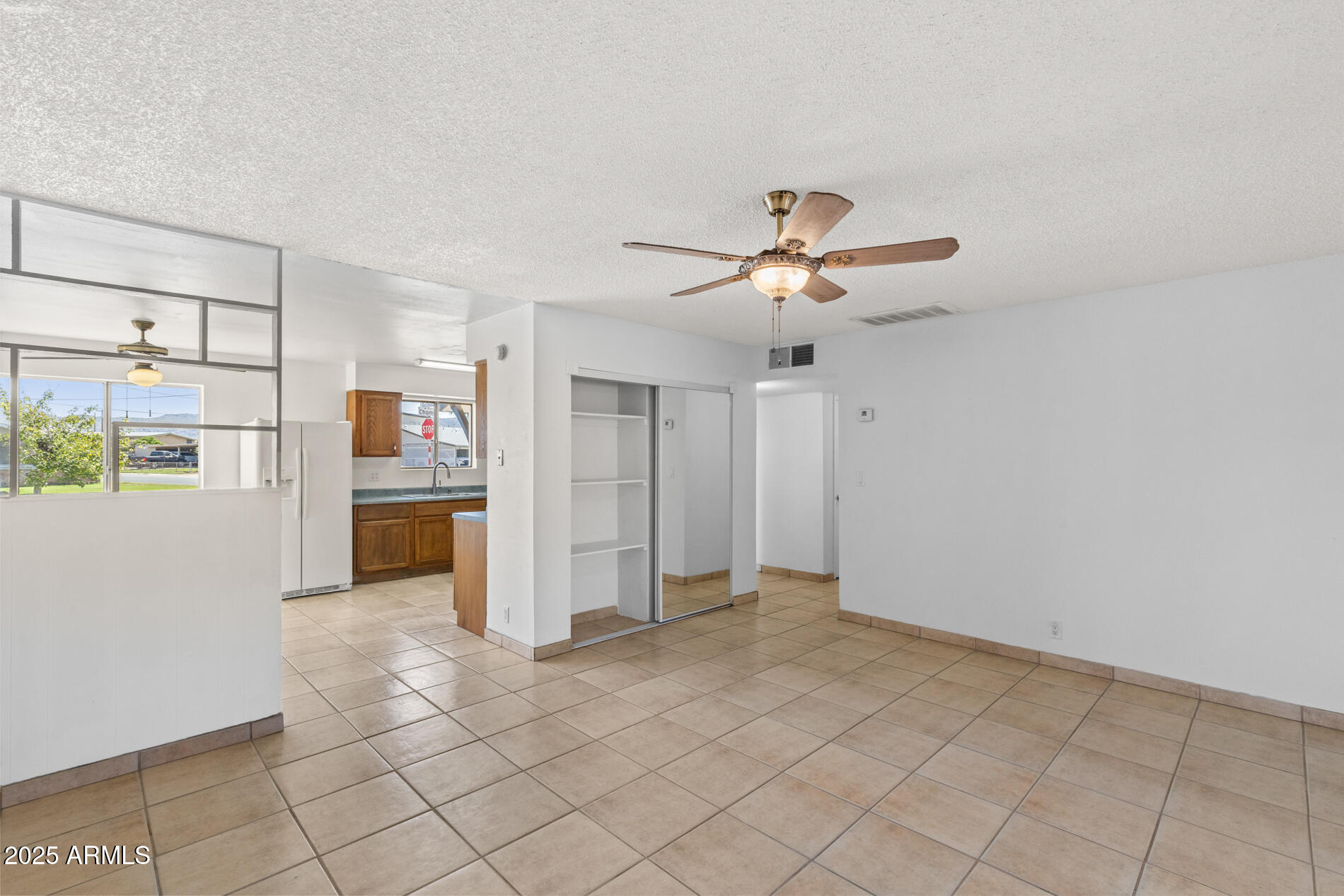 2230 East Chipman Road Phoenix, AZ 85040 - Photo 4 of 26 a view of a kitchen with a sink and a refrigerator