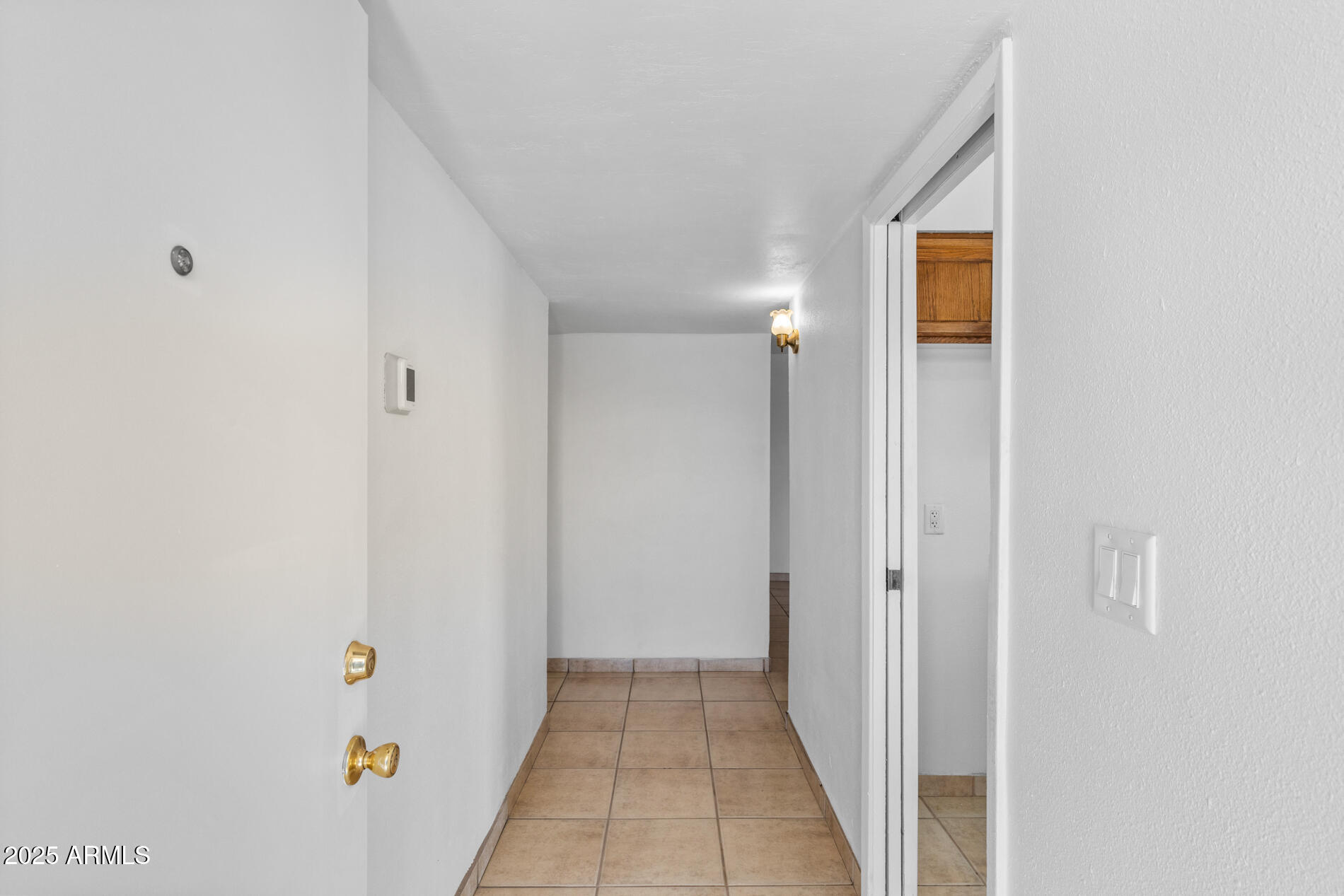 2230 East Chipman Road Phoenix, AZ 85040 - Photo 5 of 26 a view of a hallway with wooden floor