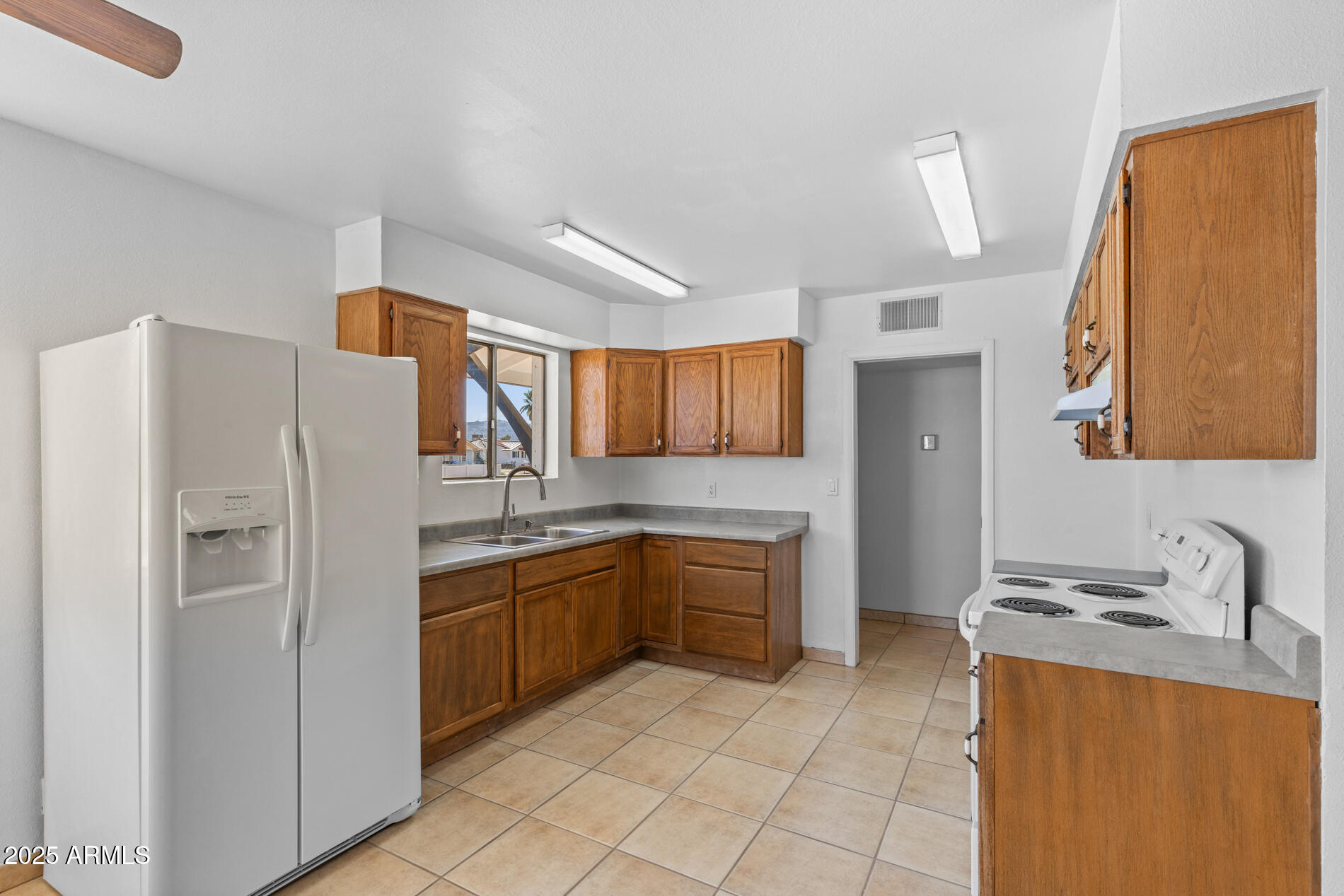 2230 East Chipman Road Phoenix, AZ 85040 - Photo 8 of 26 a kitchen with granite countertop a refrigerator and a sink