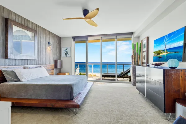 a bedroom with a bed and large window