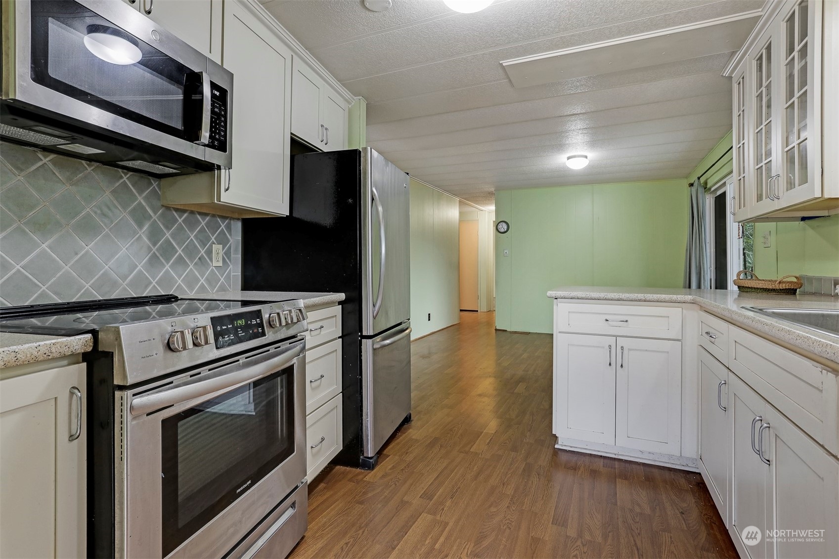 714 Wandering Creek Drive Bothell, WA 98021 - Photo 4 of 39 a kitchen with a stove microwave and sink