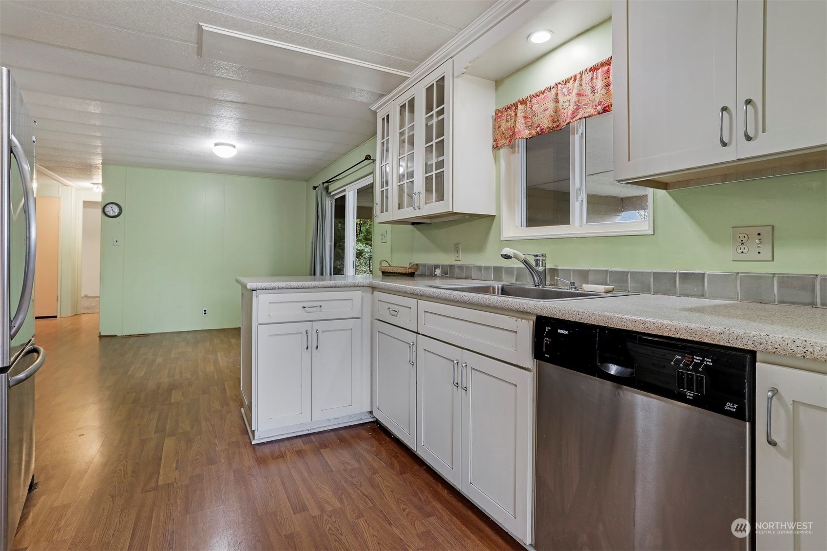 714 Wandering Creek Drive Bothell, WA 98021 - Photo 5 of 39 a kitchen with a sink cabinets and wooden floor