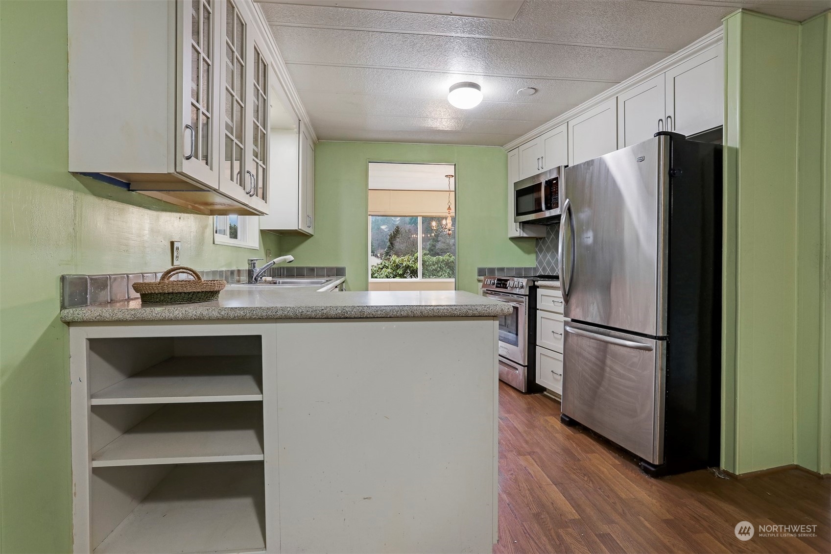 714 Wandering Creek Drive Bothell, WA 98021 - Photo 6 of 39 a kitchen with stainless steel appliances a refrigerator stove and sink