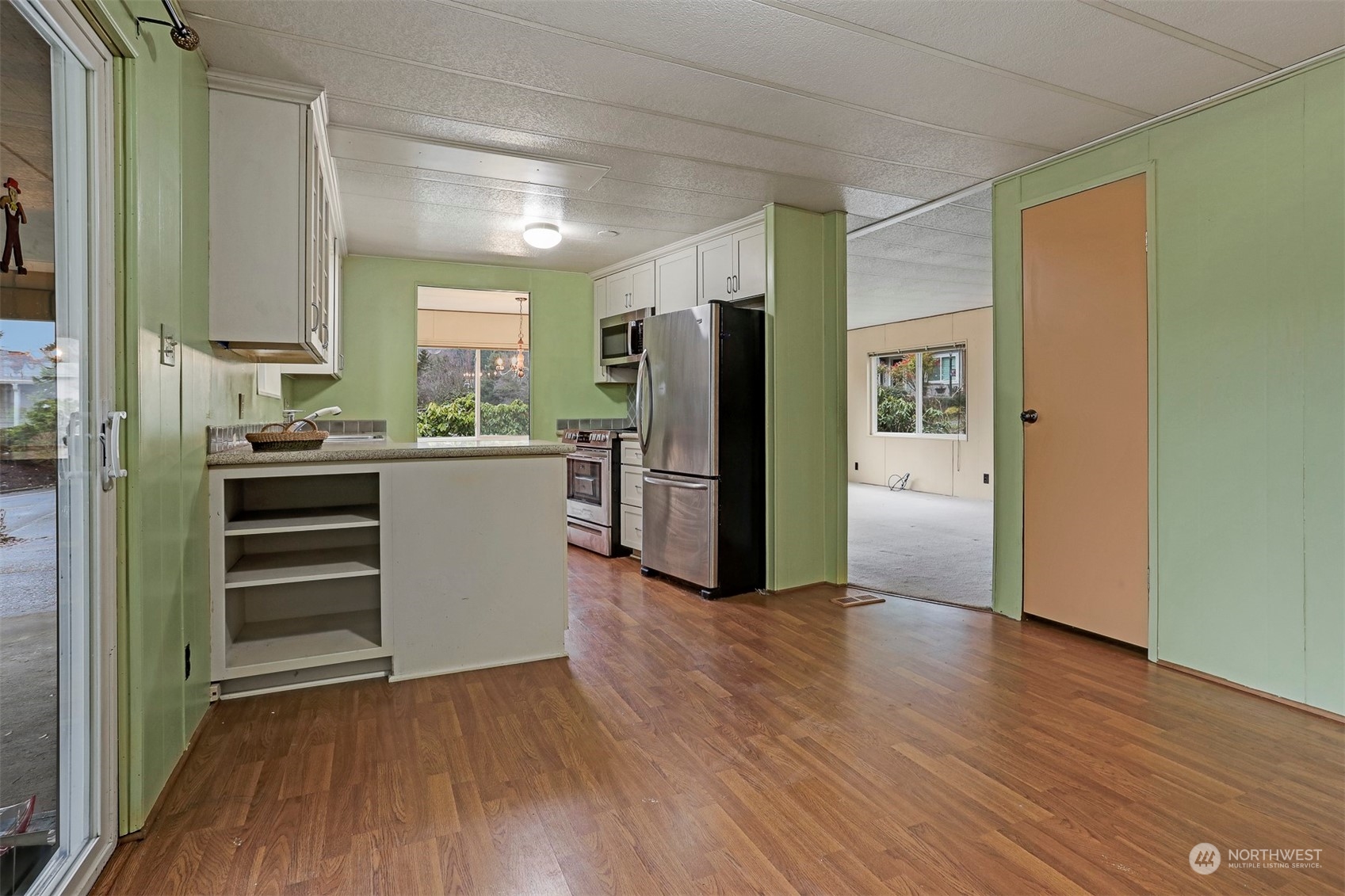 714 Wandering Creek Drive Bothell, WA 98021 - Photo 7 of 39 a kitchen with a refrigerator and a stove top oven