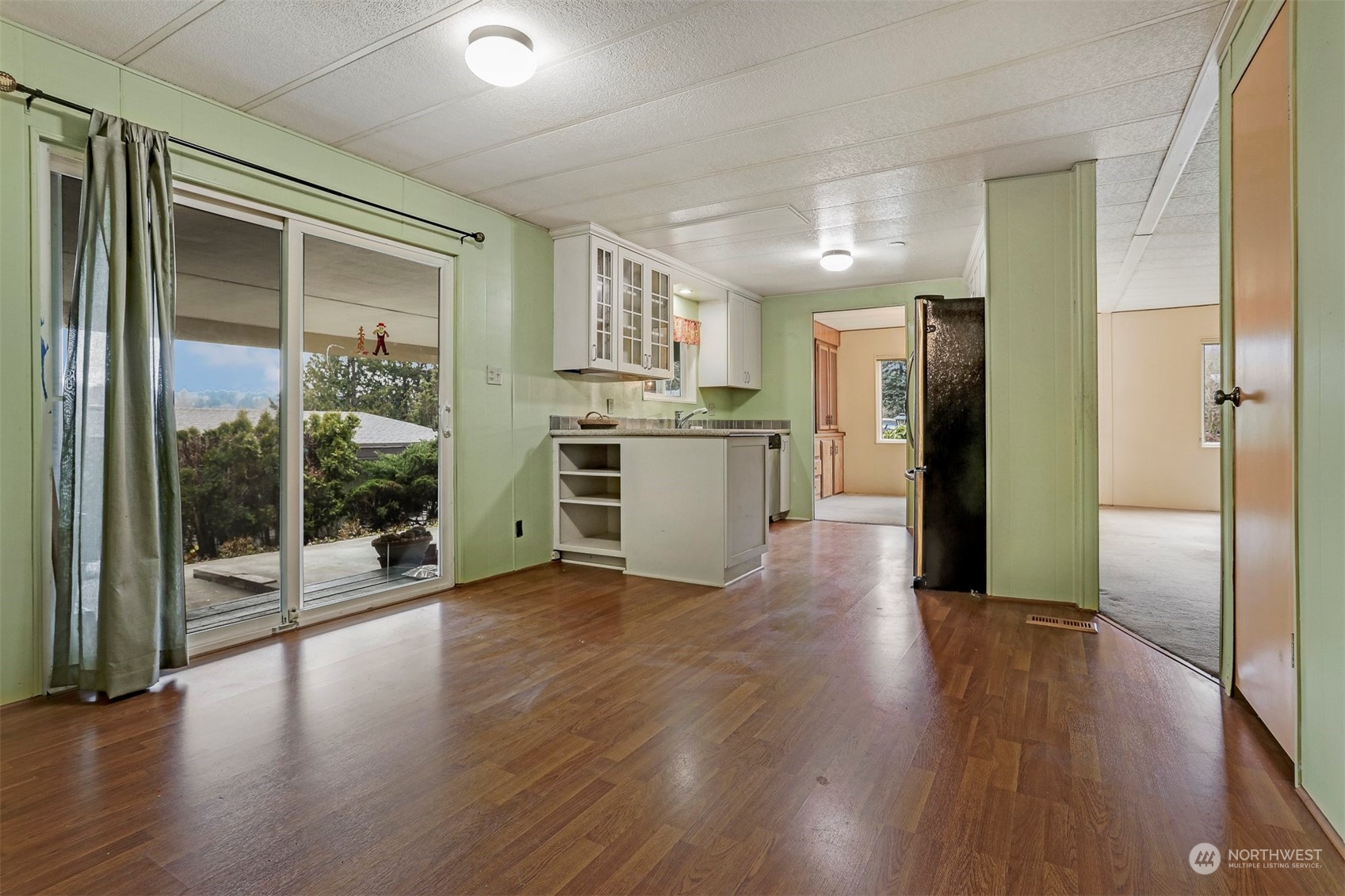 714 Wandering Creek Drive Bothell, WA 98021 - Photo 9 of 39 a view of a kitchen with refrigerator and wooden floor