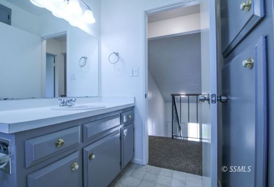 432 Debra Lane Ridgecrest, CA 93555 - Photo 32 of 39 a bathroom with a granite countertop sink a mirror and a vanity