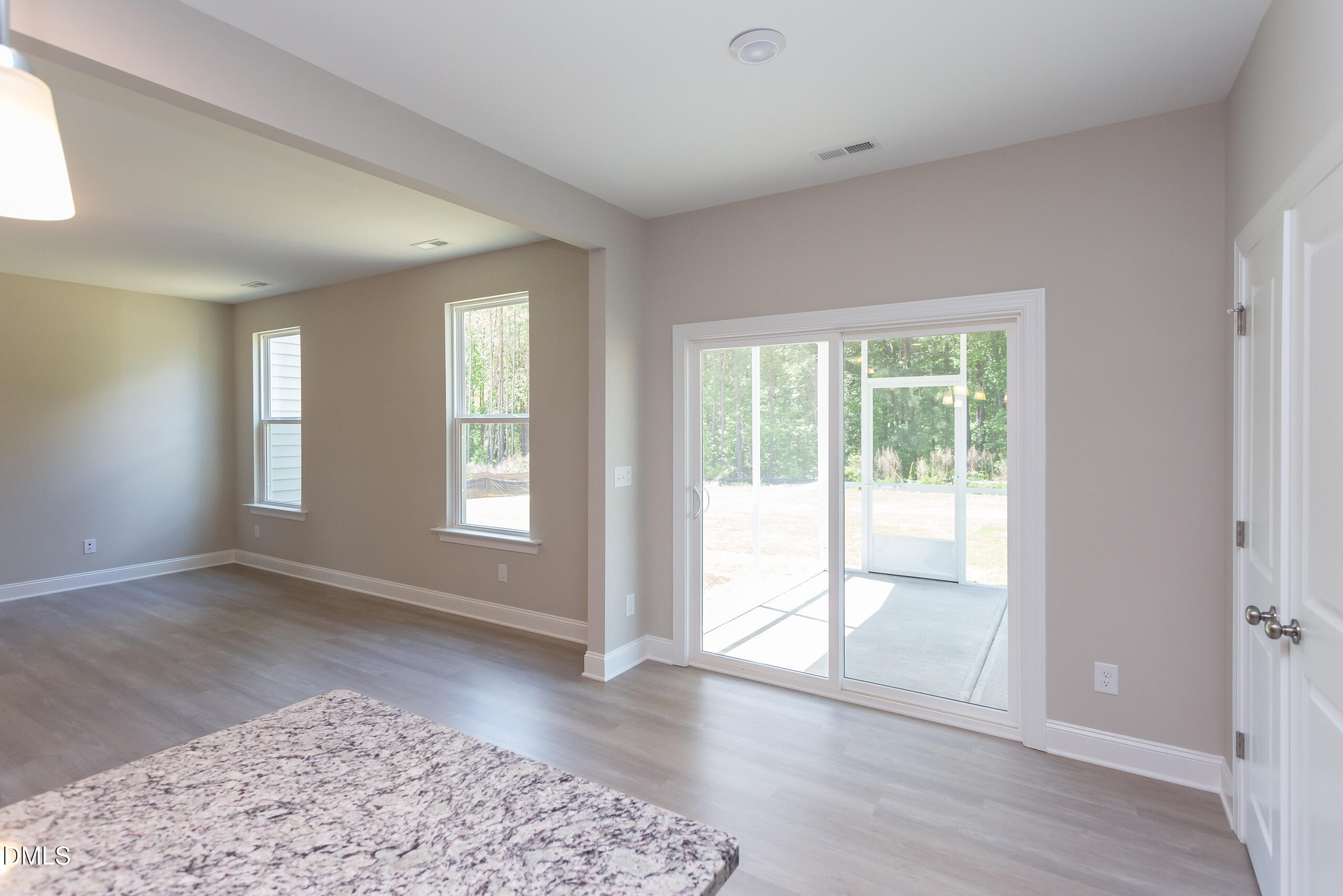 263 Gilliland Road Siler City, NC 27344 - Photo 9 of 31 an empty room with wooden floor and windows