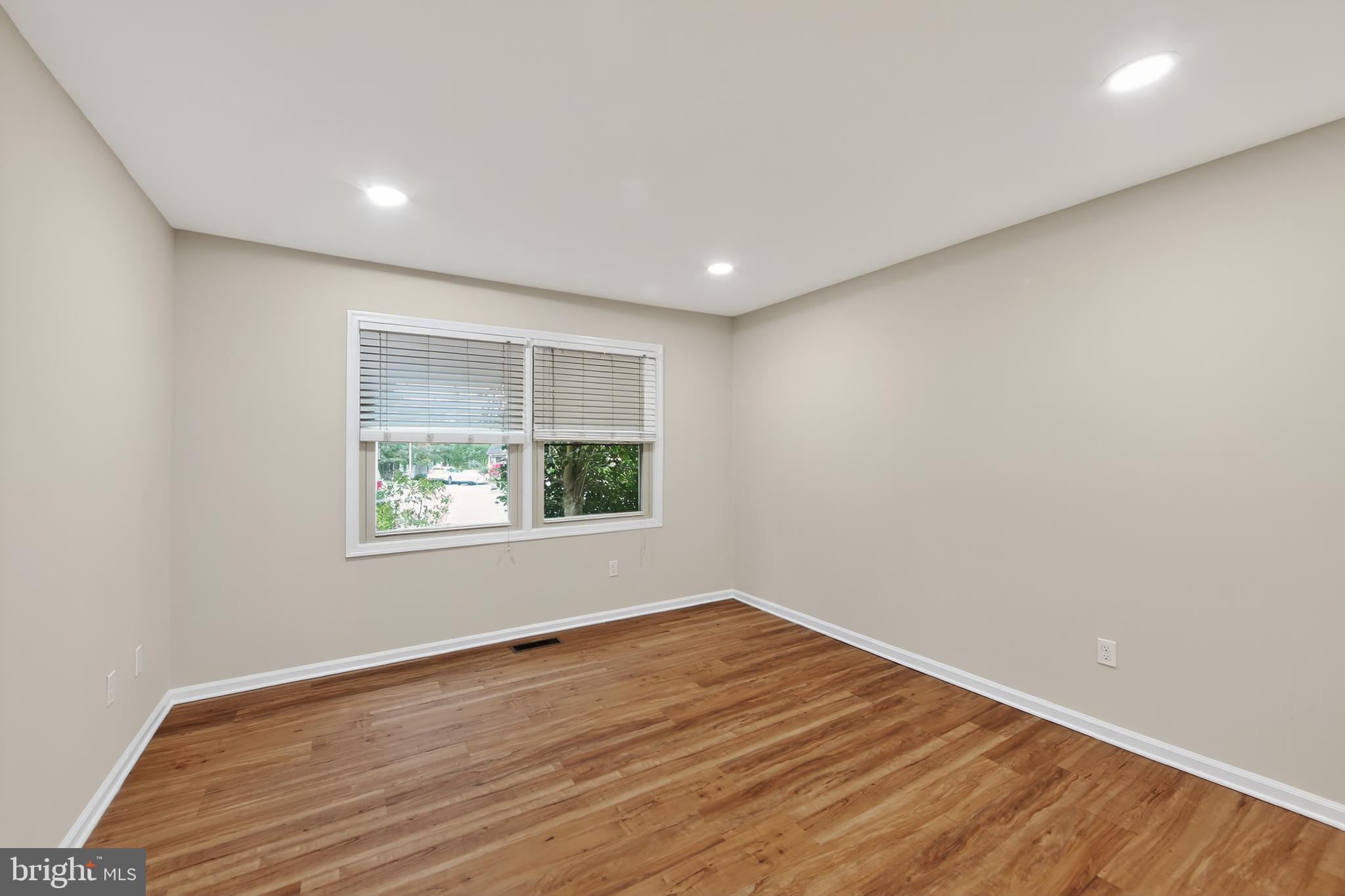 107 Reveille Road, Unit 107 Chesterbrook, PA 19087 - Photo 12 of 22 a view of empty room with wooden floor and fan