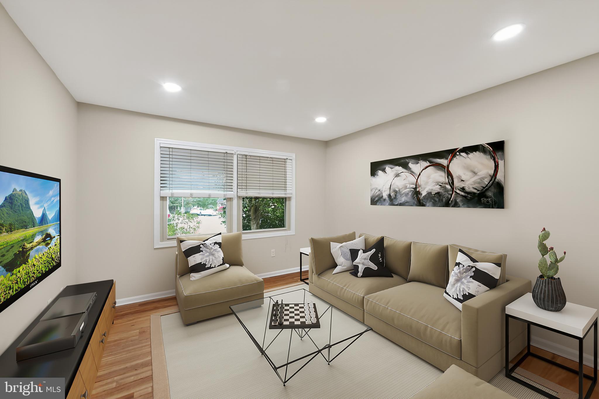 107 Reveille Road, Unit 107 Chesterbrook, PA 19087 - Photo 3 of 22 a living room with furniture and a flat screen tv