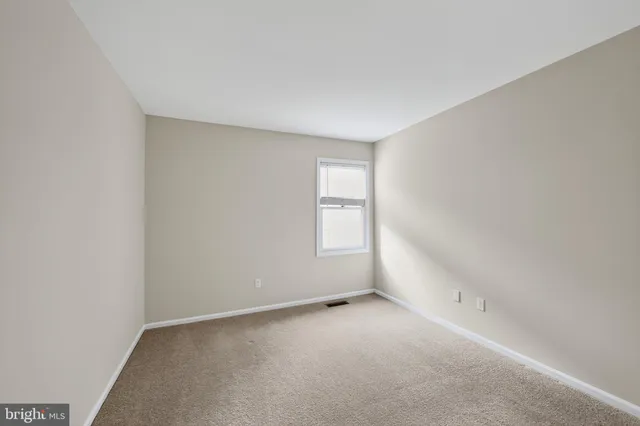 a view of an empty room and a window