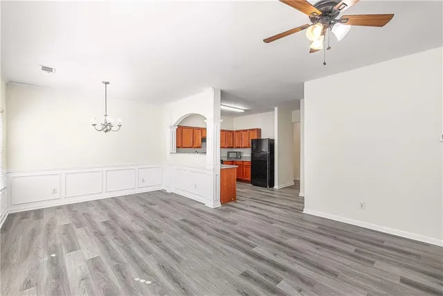 a view of empty room with wooden floor