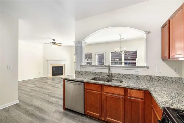 a kitchen with stainless steel appliances granite countertop a refrigerator and a stove top oven