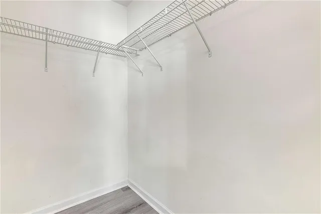 a white bath tub sitting next to a shower