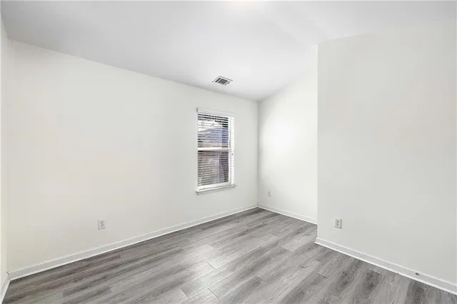 a view of hallway with wooden floor