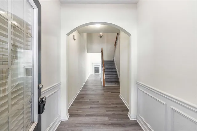 a view of a hallway with wooden floor and staircase