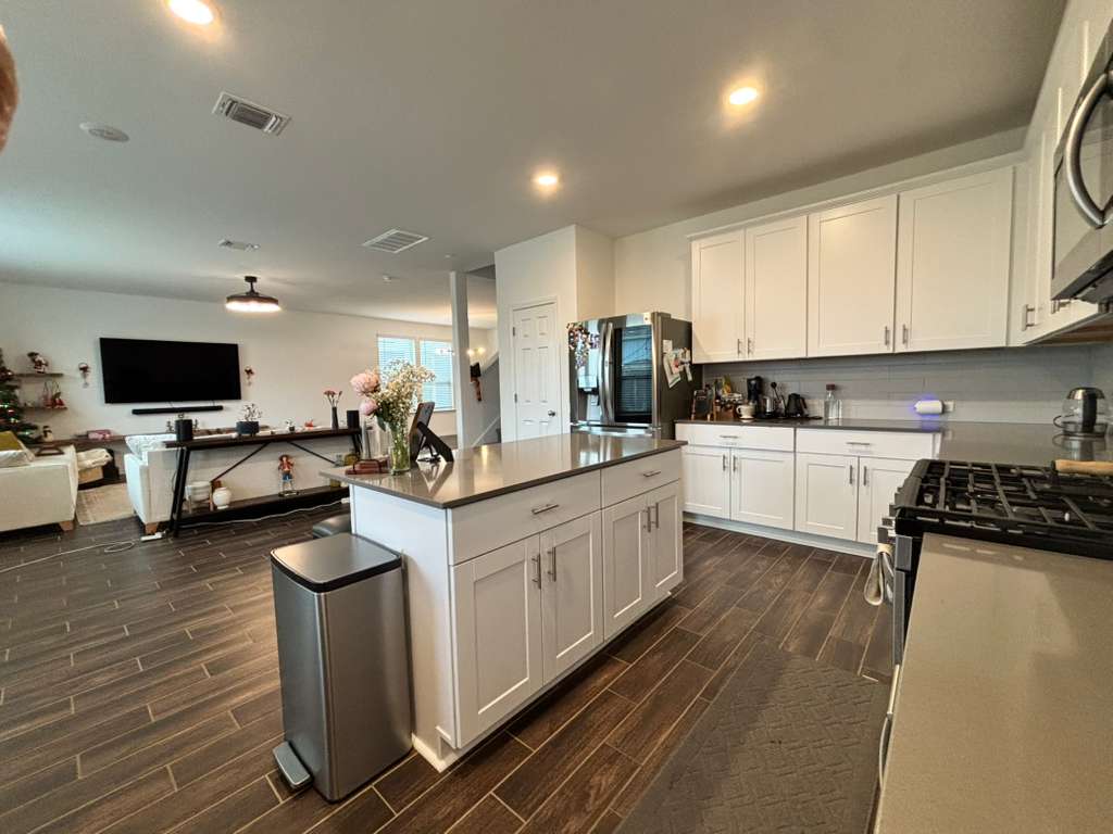 1512 Hope Ranch Road Leander, TX 78641 - Photo 13 of 27 a kitchen with sink a stove and cabinets