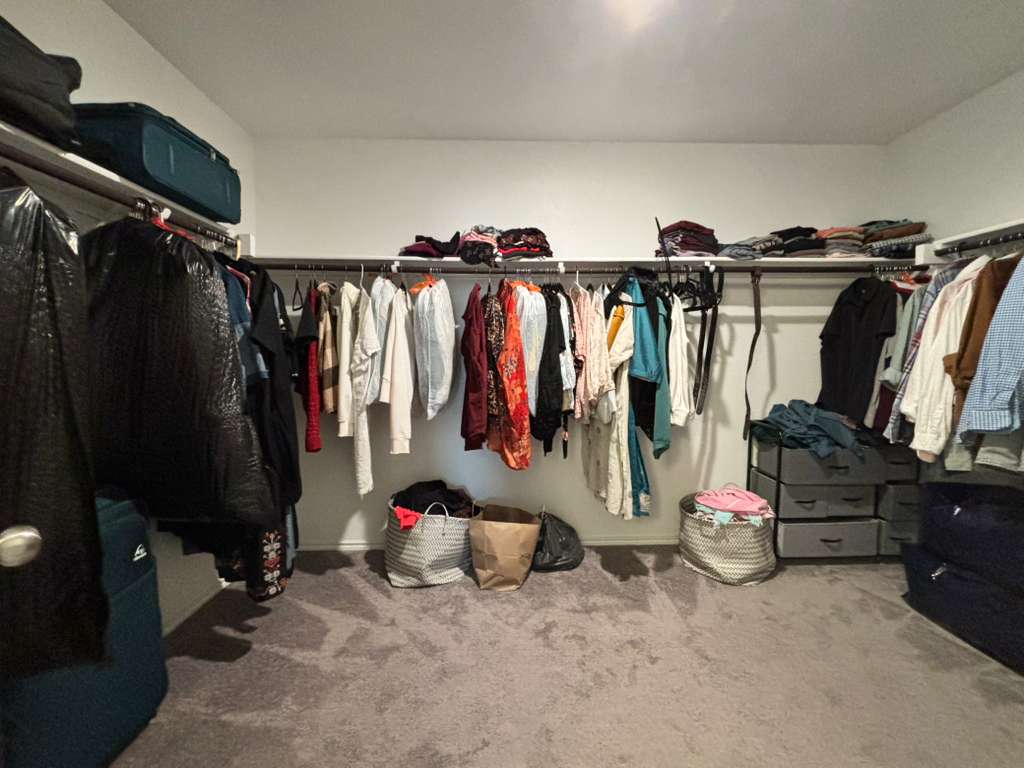 1512 Hope Ranch Road Leander, TX 78641 - Photo 18 of 27 a view of walk in closet with clothes and shoes