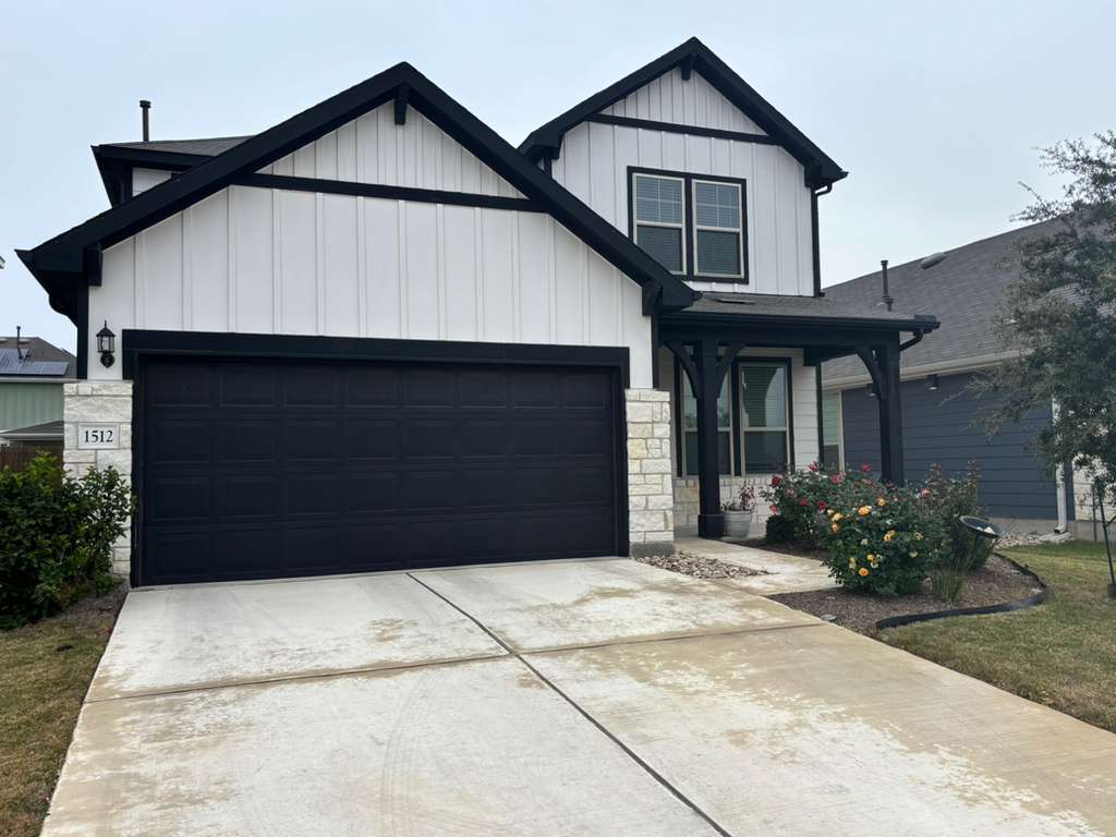1512 Hope Ranch Road Leander, TX 78641 - Photo 2 of 27 a front view of a house with a yard and garage