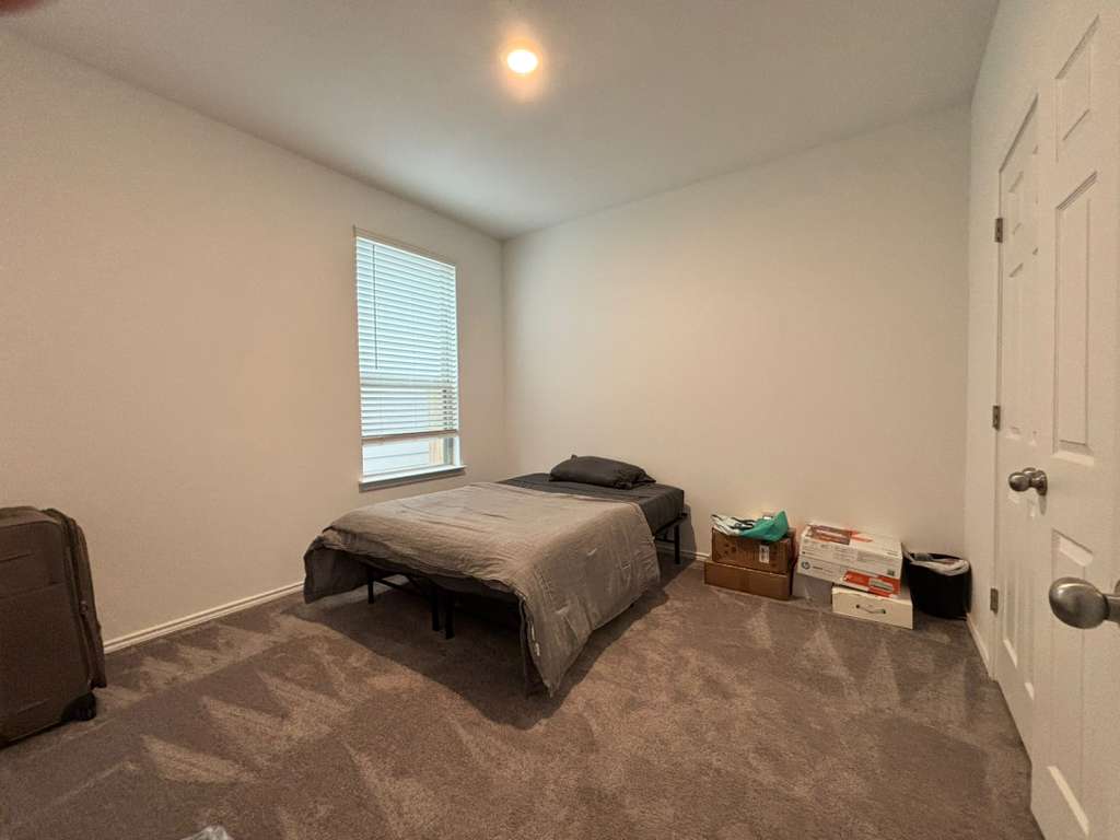 1512 Hope Ranch Road Leander, TX 78641 - Photo 7 of 27 a bedroom with a bed and a window