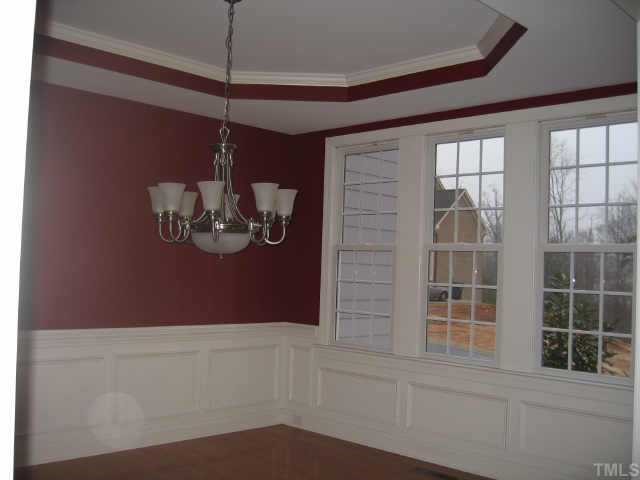 2924 Elmfield Street Raleigh, NC 27614 - Photo 2 of 10 Formal dining room features a trey ceiling, wainscotting, & triple window.