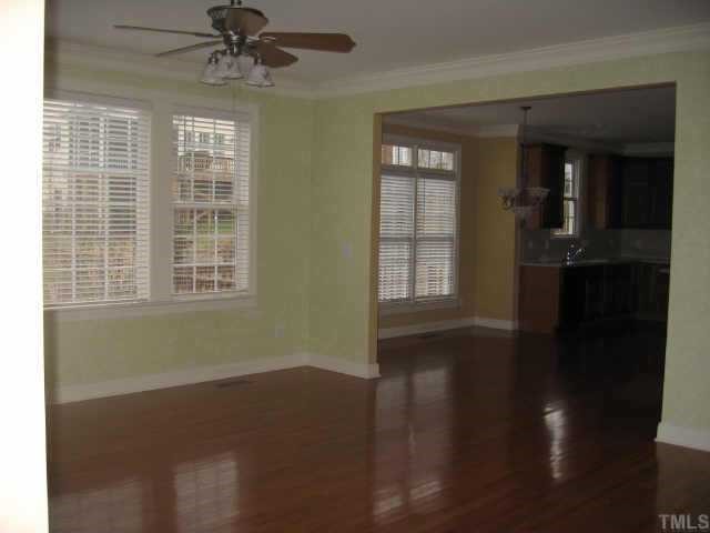 2924 Elmfield Street Raleigh, NC 27614 - Photo 3 of 10 Large family room has hardwood floors, fireplace with gas logs, & a ceiling fan.