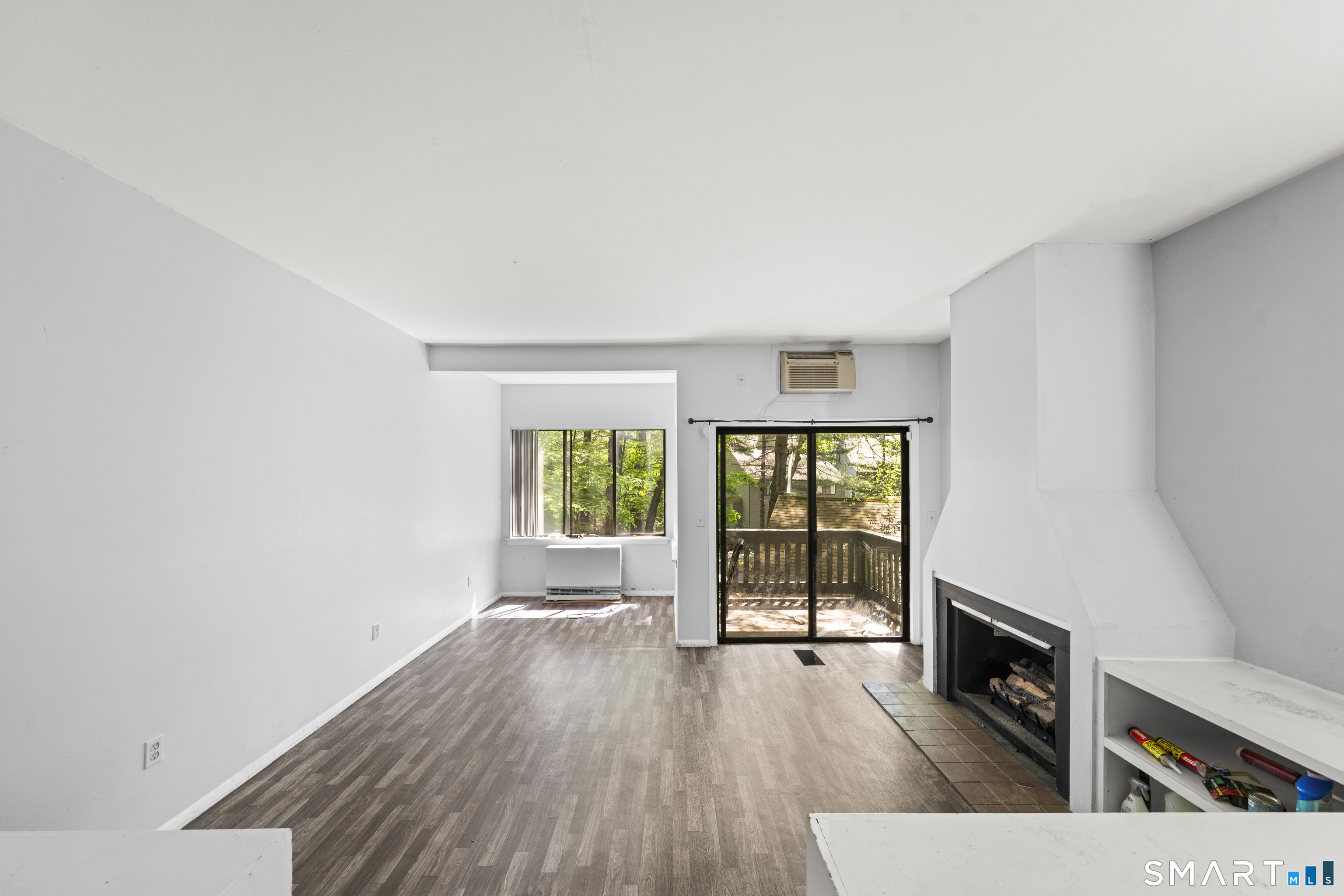 39 Evergreen Road, Unit 39 Torrington, CT 06790 - Photo 8 of 27 a view of an empty room with wooden floor and a window