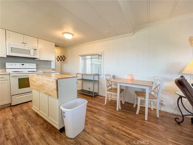 a kitchen with a stove a sink a refrigerator and window