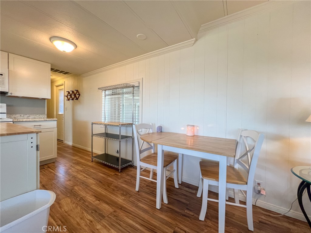 650 Channel Way, Unit 650 Needles, CA 92363 - Photo 12 of 60 a view of a dining room with furniture window and wooden floor