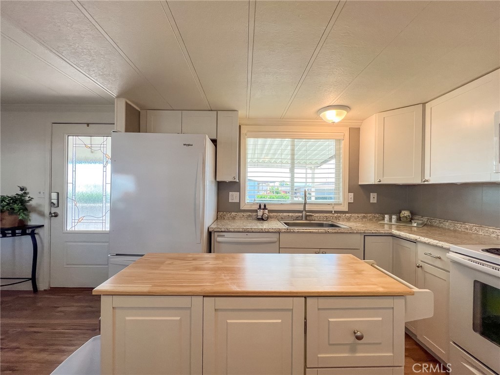 650 Channel Way, Unit 650 Needles, CA 92363 - Photo 13 of 60 a kitchen with a stove a sink a refrigerator and window