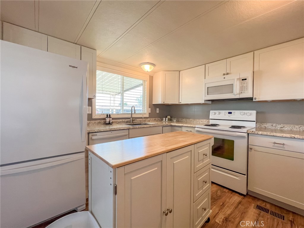 650 Channel Way, Unit 650 Needles, CA 92363 - Photo 14 of 60 a kitchen with cabinets appliances a sink and a window