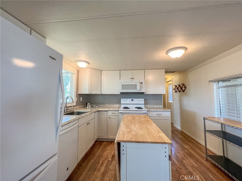 650 Channel Way, Unit 650 Needles, CA 92363 - Photo 15 of 60 a kitchen with a sink a stove top oven and cabinetry