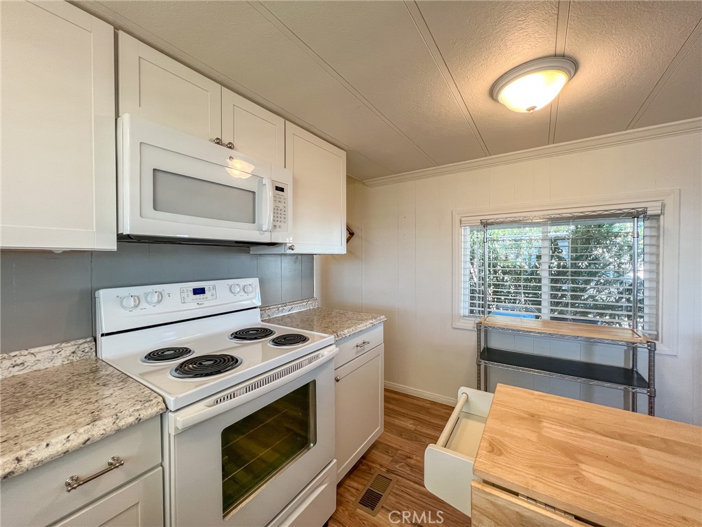 650 Channel Way, Unit 650 Needles, CA 92363 - Photo 19 of 60 a kitchen with a stove and a white cabinets