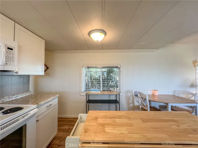 a room with a chandelier fan and a window