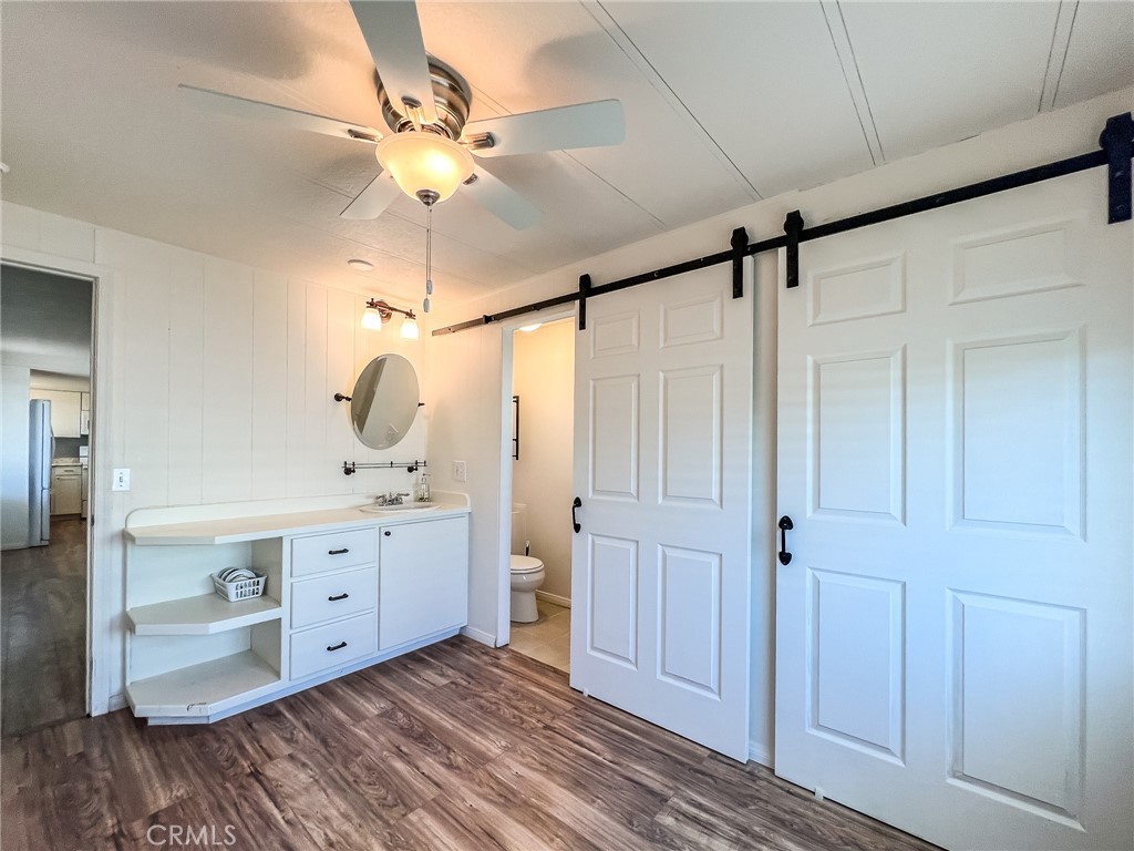 650 Channel Way, Unit 650 Needles, CA 92363 - Photo 24 of 60 a room with a chandelier fan and a window