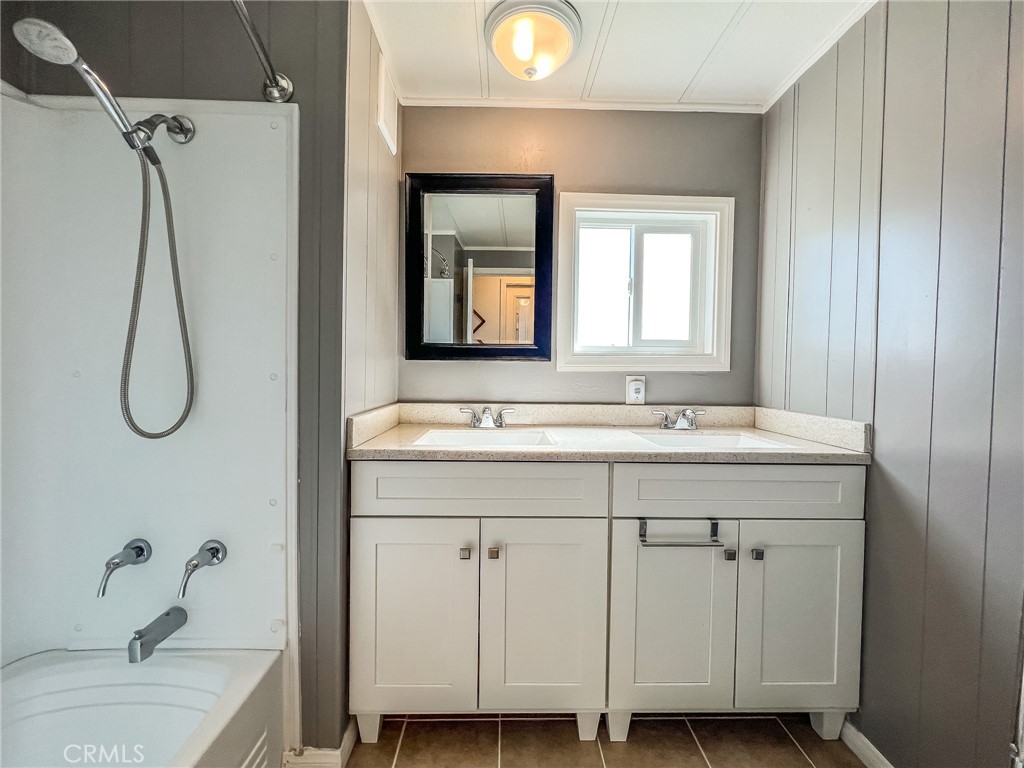 650 Channel Way, Unit 650 Needles, CA 92363 - Photo 35 of 60 a bathroom with a granite countertop sink a vanity and a mirror