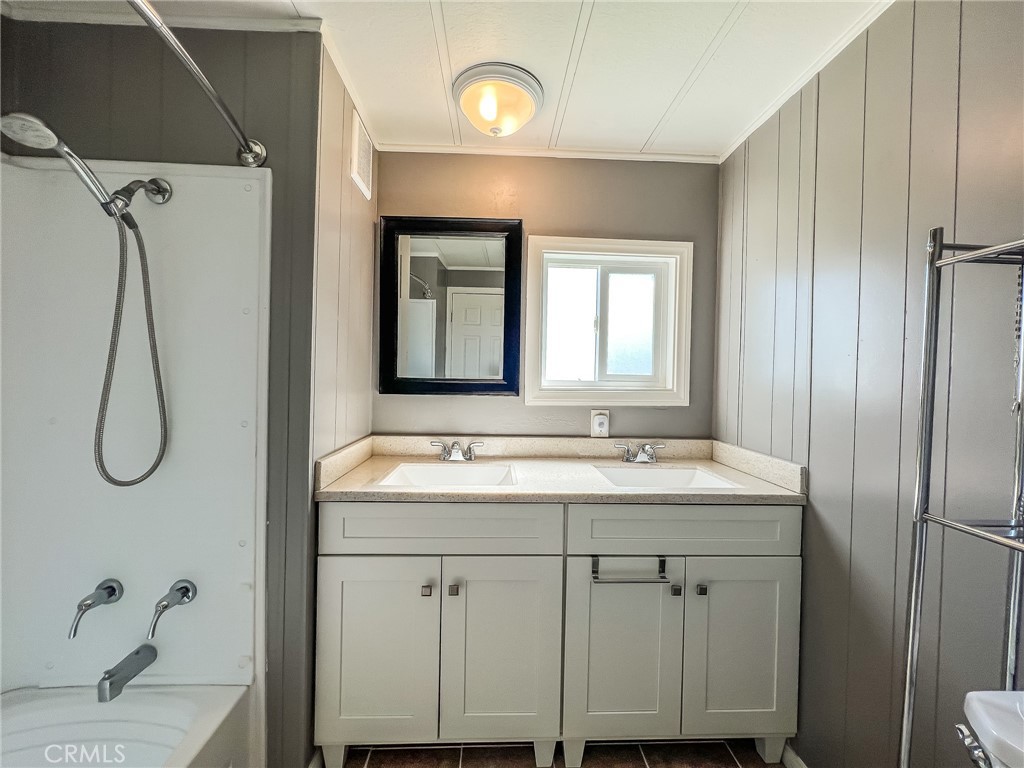 650 Channel Way, Unit 650 Needles, CA 92363 - Photo 36 of 60 a bathroom with a granite countertop sink a toilet and a mirror