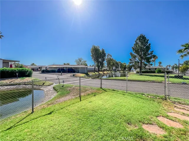 a view of a swimming pool with outdoor seating and lake view