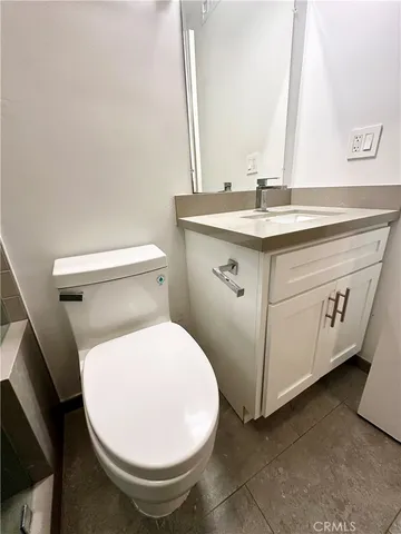 a bathroom with a sink mirror vanity and toilet